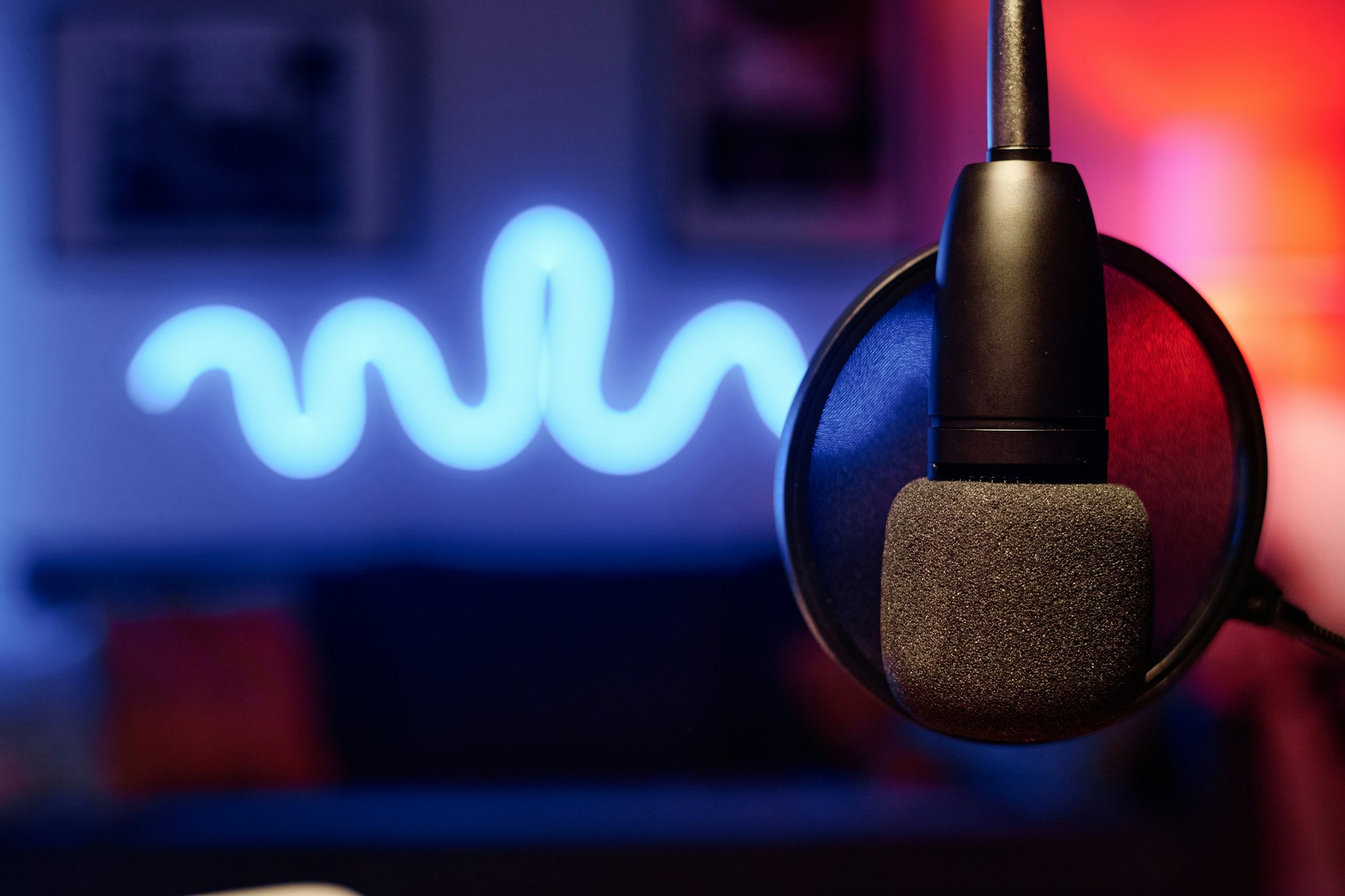 Microphone hanging in front of camera over workplace of radio presenter